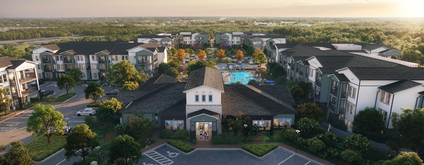 a group of apartments in a complex with lush landscaping