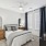 bedroom with a large window and modern decor