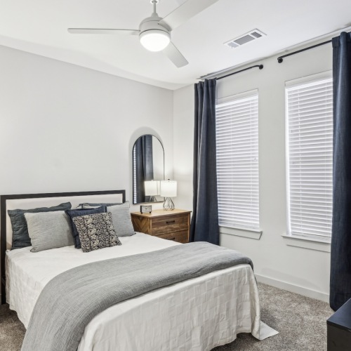 A Diverse Range of Floor Plans bedroom with a large window and modern decor