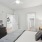 bedroom with ample space around the bed and bright lighting