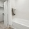 bath area with a tub and a closet